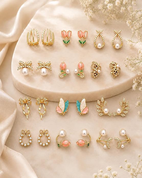 Gold Earrings Collection Gold earrings collection displayed on a cream fabric background