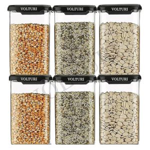 Assorted seeds and grains stored in clear containers for kitchen use
