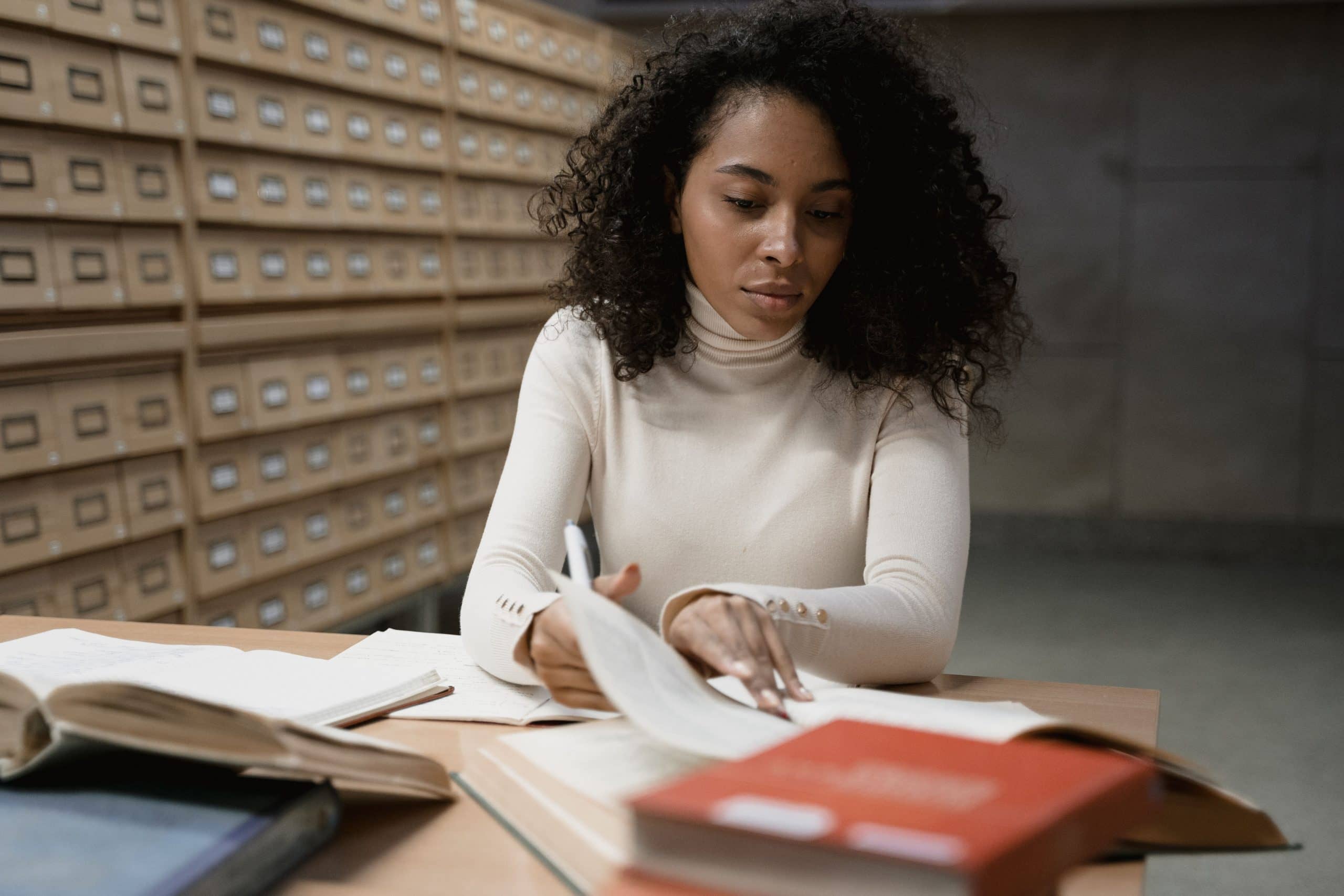 Student studying and writing notes at a desk